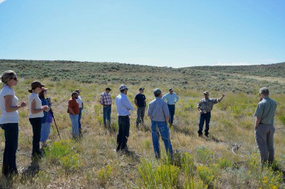 Ray Owens explains to the group how his artificial seeps work to create additional brood-rearing habitat for sage grouse. Photo: Deborah Richie, SGI