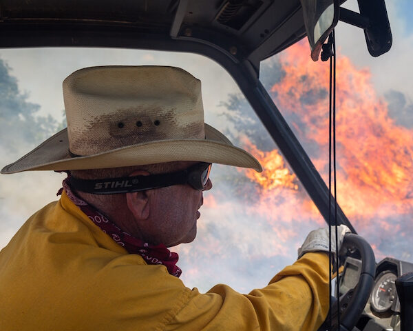 chuck coffey driving through prescribed fire on his ranch in Arbuckle Mountains, Oklahoma
